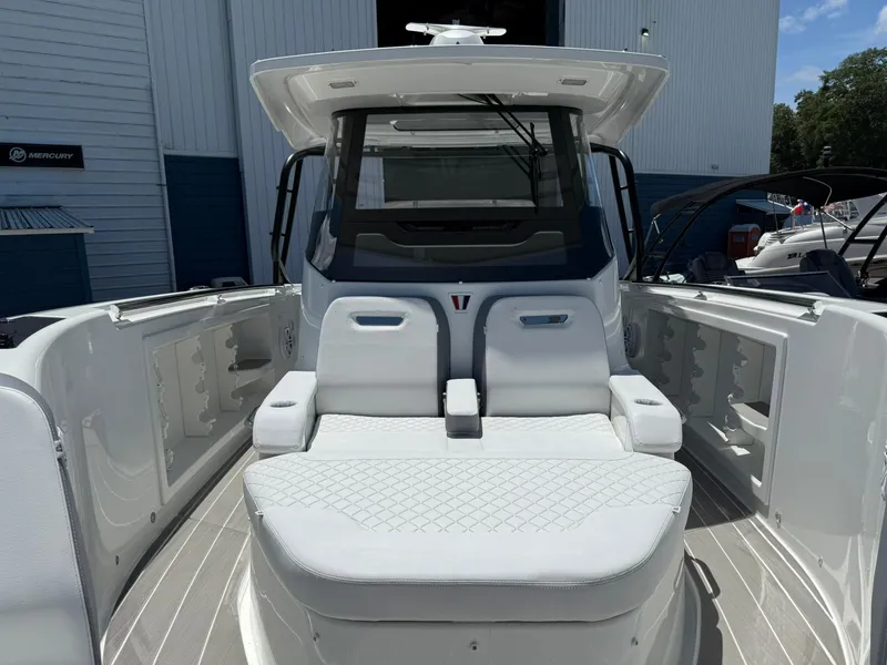 Slide: The Image of 2025 Wellcraft 38 T-Top boat interior with white seating and modern design. - 11