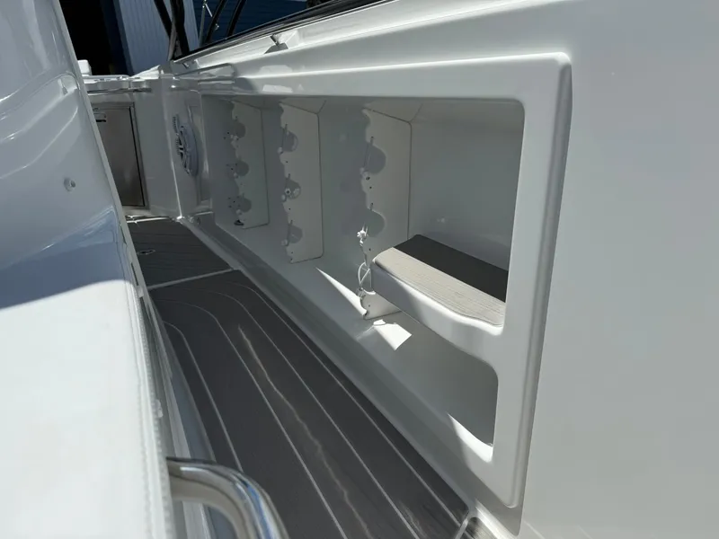 Slide: The Image of 2025 Wellcraft 38 T-Top boat interior with storage compartments and sleek design. - 15