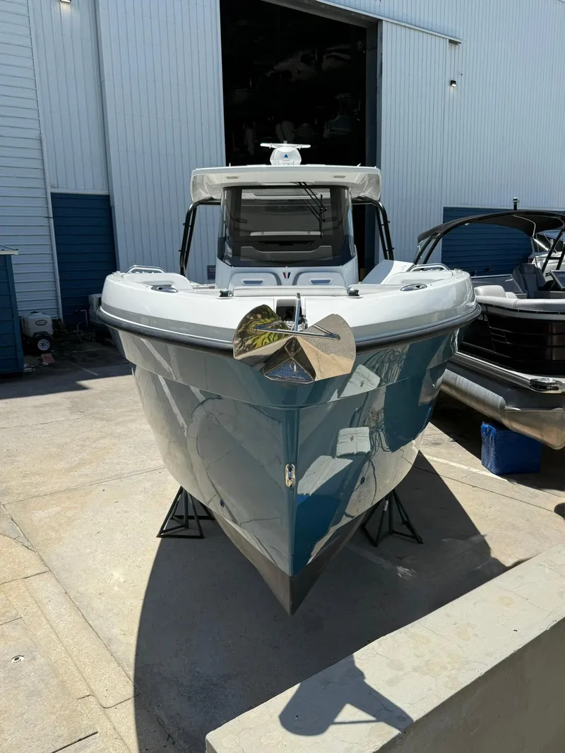 Slide: The Image of 2025 Wellcraft 38 T-Top boat in a marina, showcasing sleek design and modern features. - 2