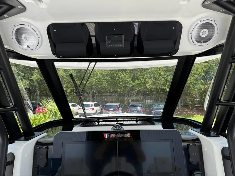 Slide: The Image of 2025 Wellcraft 38 T-Top boat interior with advanced dashboard and speakers. - 20