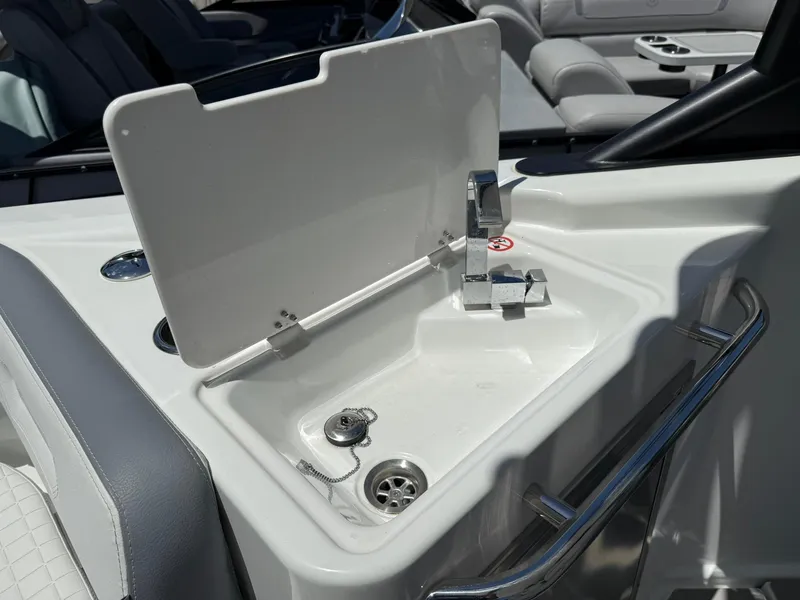 Slide: The Image of 2025 Wellcraft 38 T-Top boat sink with chrome faucet and white interior. - 22