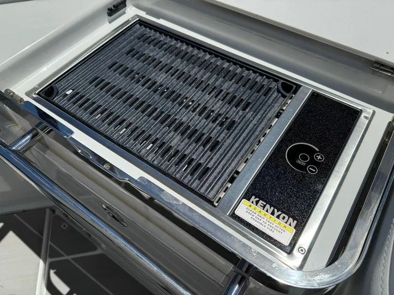 Slide: The Image of Built-in Kenyon grill on 2025 Wellcraft 38 T-Top boat, featuring sleek stainless steel design. - 25