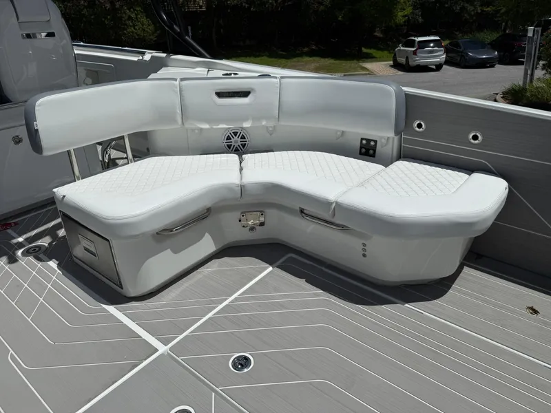 Slide: The Image of 2025 Wellcraft 38 T-Top boat with white cushioned seating and sleek deck design. - 29