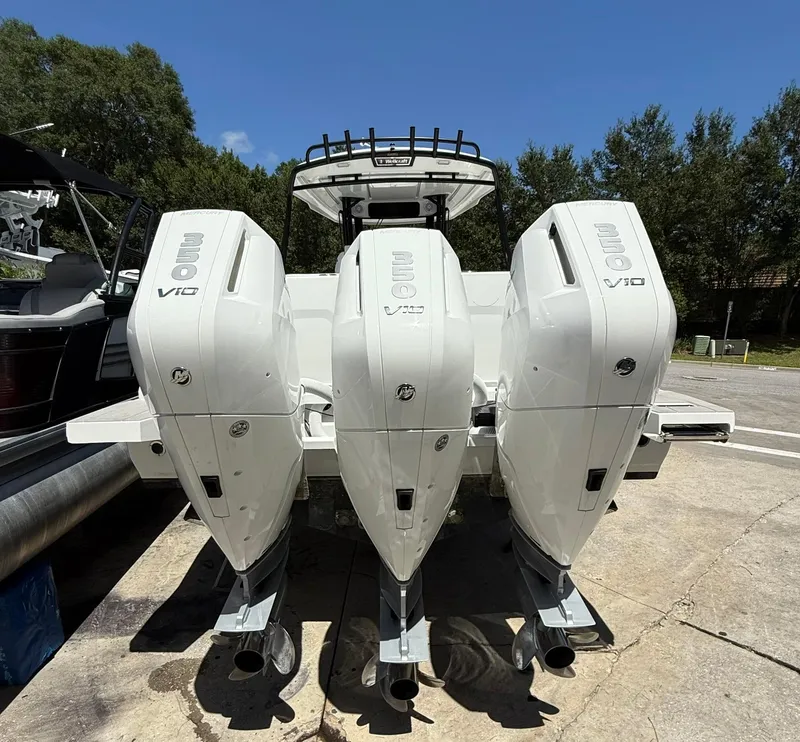 Slide: The Image of 2025 Wellcraft 38 T-Top boat with triple V10 engines, parked outdoors. - 3