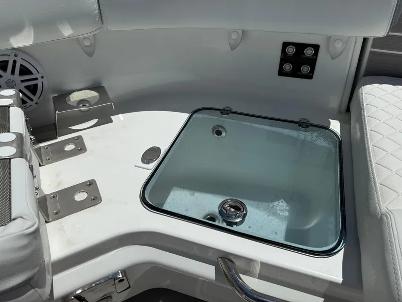 Slide: The Image of 2025 Wellcraft 38 T-Top boat interior with seating and storage compartment. - 30