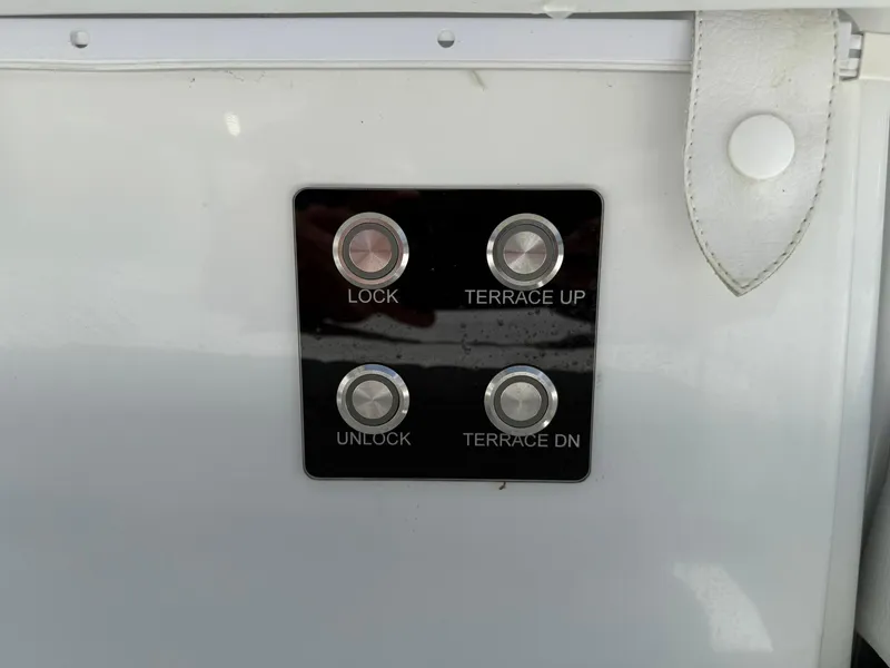 Slide: The Image of Control panel on 2025 Wellcraft 38 T-Top boat with lock and terrace buttons. - 31