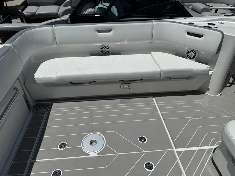 Slide: The Image of 2025 Wellcraft 38 T-Top boat interior with white seating and modern deck design. - 32