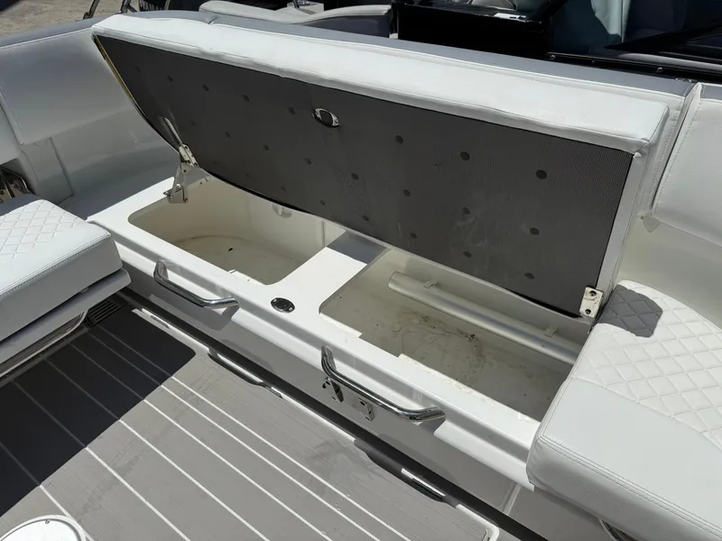 Slide: The Image of Open storage compartment on 2025 Wellcraft 38 T-Top boat with white seating. - 33