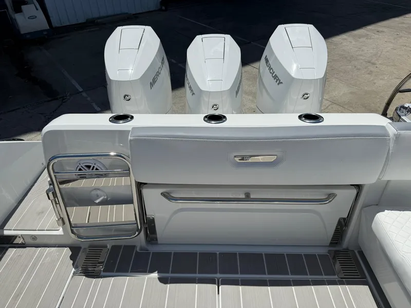 Slide: The Image of 2025 Wellcraft 38 T-Top boat with triple Mercury outboard engines, rear deck view. - 34