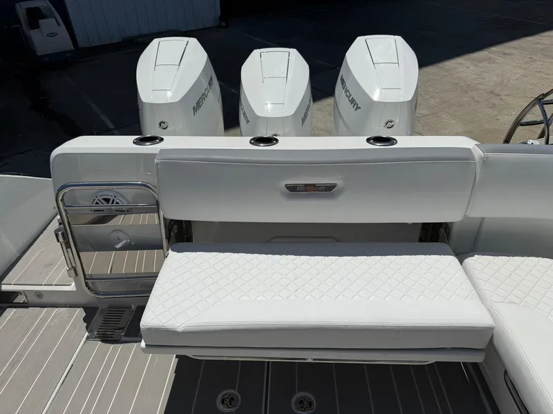 Slide: The Image of 2025 Wellcraft 38 T-Top boat with triple Mercury engines and cushioned seating. - 35