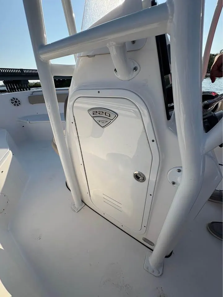 Slide: The Image of 2019 Tidewater 220 LXF boat console with storage compartment, white finish. - 7
