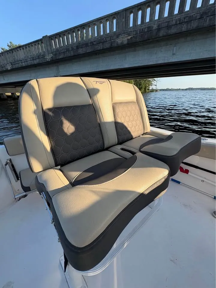 Slide: The Image of 2019 Tidewater 220 LXF boat seats under a bridge on a sunny day. - 8