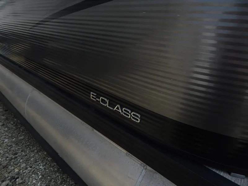 Slide: The Image of 2024 Qwest Splash Pad 822 E-Class pontoon boat, sleek black exterior detail. - 12