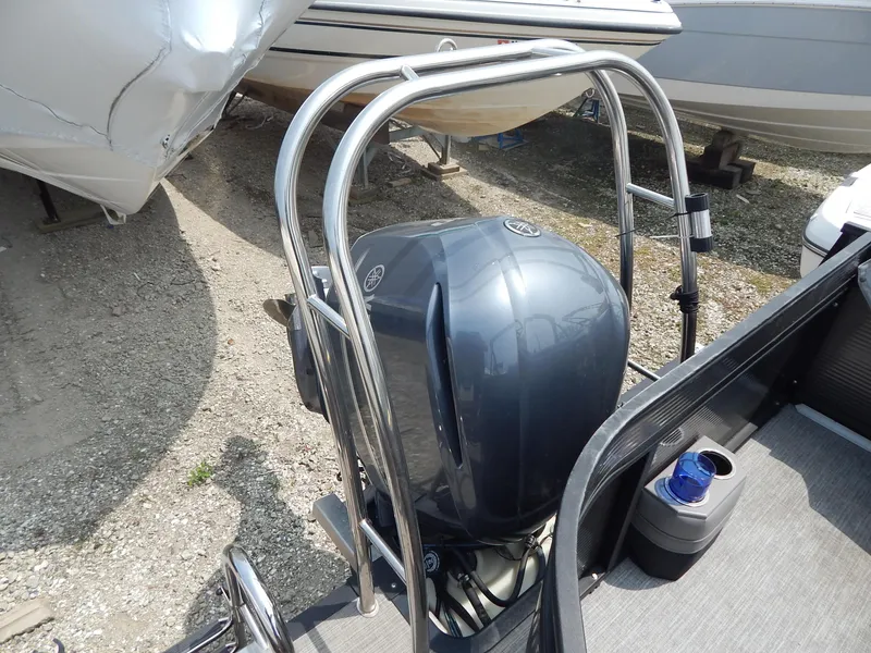 Slide: The Image of 2024 Qwest Splash Pad 822 boat with Yamaha outboard motor, docked on gravel. - 15