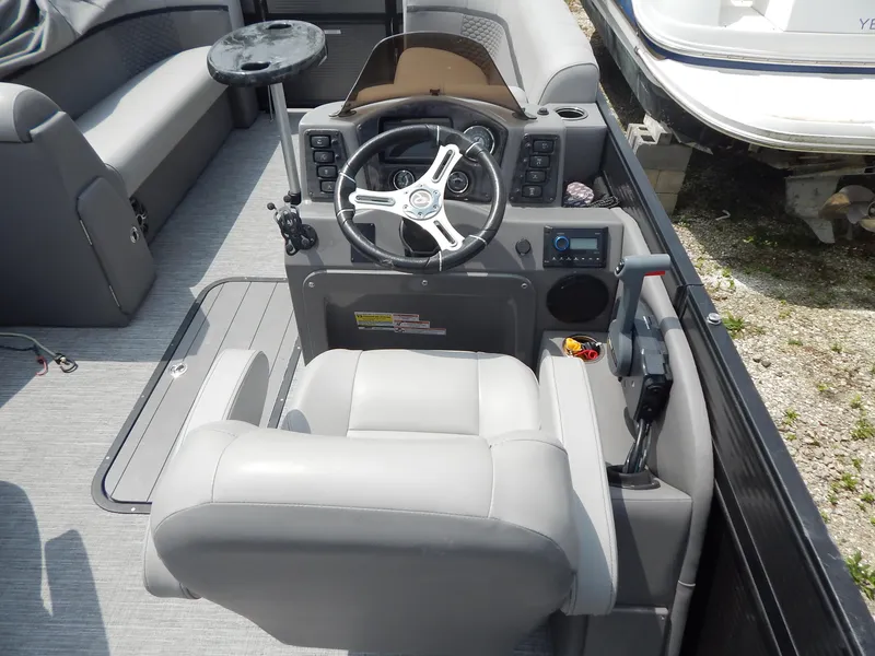 Slide: The Image of 2024 Qwest Splash Pad 822 boat interior with steering wheel and control panel. - 19