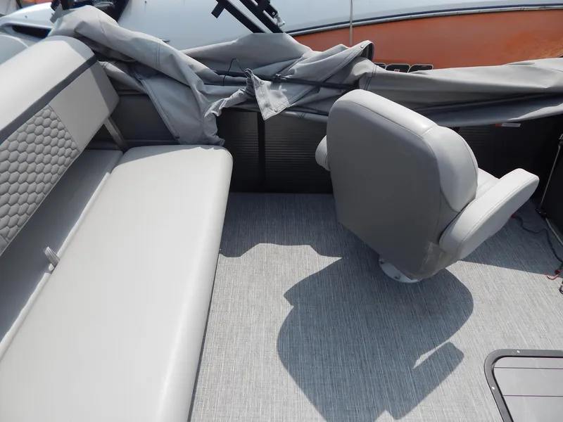 Slide: The Image of 2024 Qwest Splash Pad 822 boat interior with gray seating and flooring. - 20