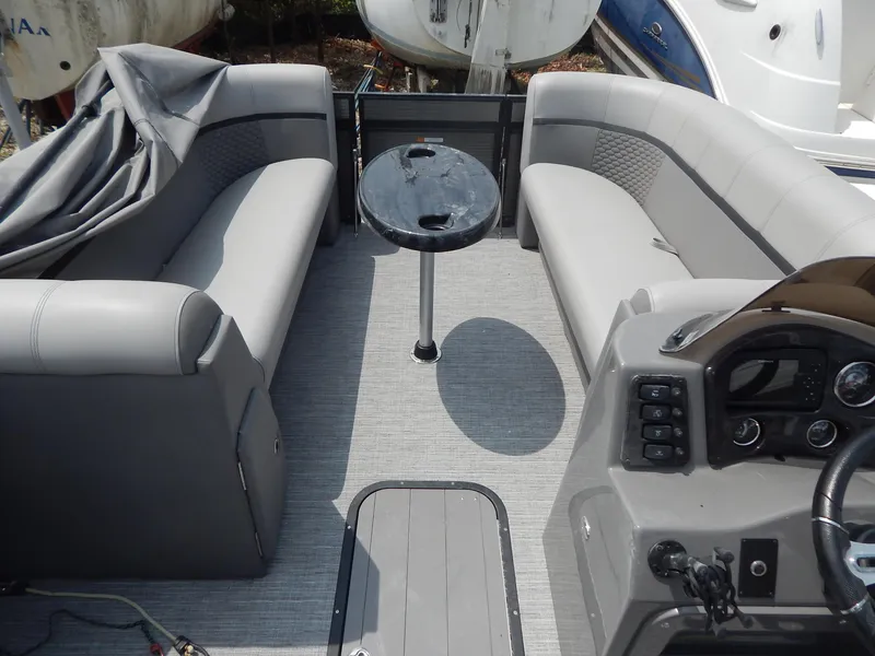 Slide: The Image of Interior of 2024 Qwest Splash Pad 822 pontoon boat with gray seating and central table. - 21