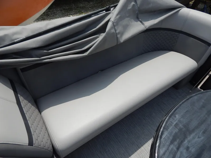 Slide: The Image of Gray seating area on a 2024 Qwest Splash Pad 822 boat, partially covered. - 23