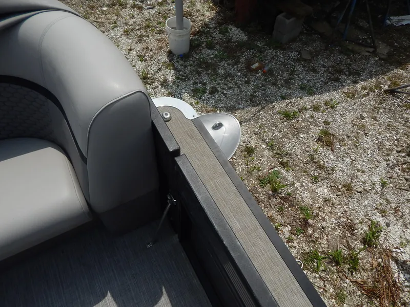 Slide: The Image of 2024 Qwest Splash Pad 822 boat interior with gray seating and textured flooring. - 25