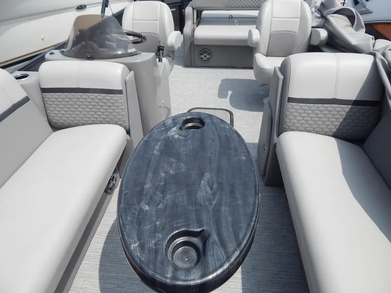 Slide: The Image of 2024 Qwest Splash Pad 822 interior with gray seating and oval table. - 26