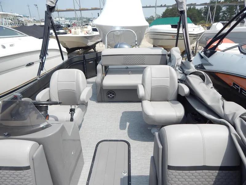 Slide: The Image of 2024 Qwest Splash Pad 822 pontoon boat interior with gray seating and helm. - 27
