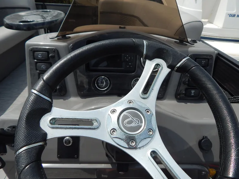 Slide: The Image of Steering wheel of 2024 Qwest Splash Pad 822 boat, featuring control panel and dashboard. - 28