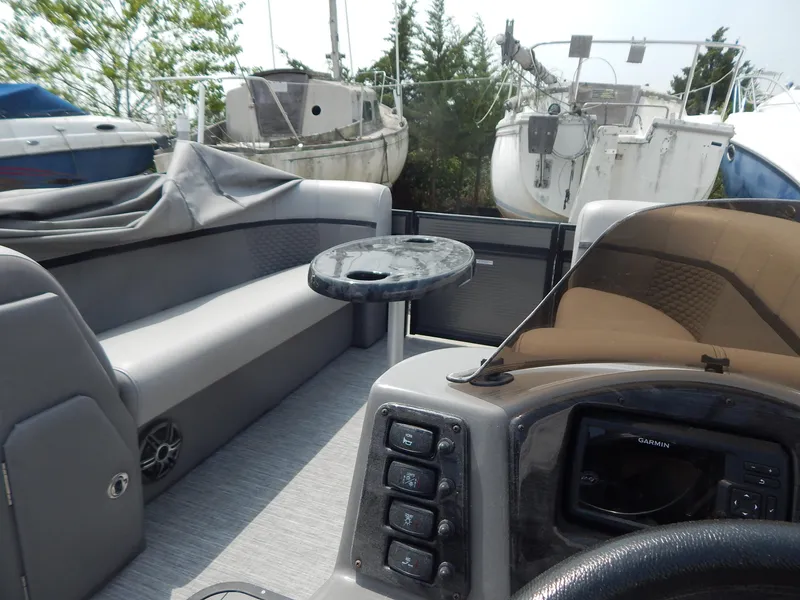 Slide: The Image of 2024 Qwest Splash Pad 822 boat interior with seating and control panel. - 34
