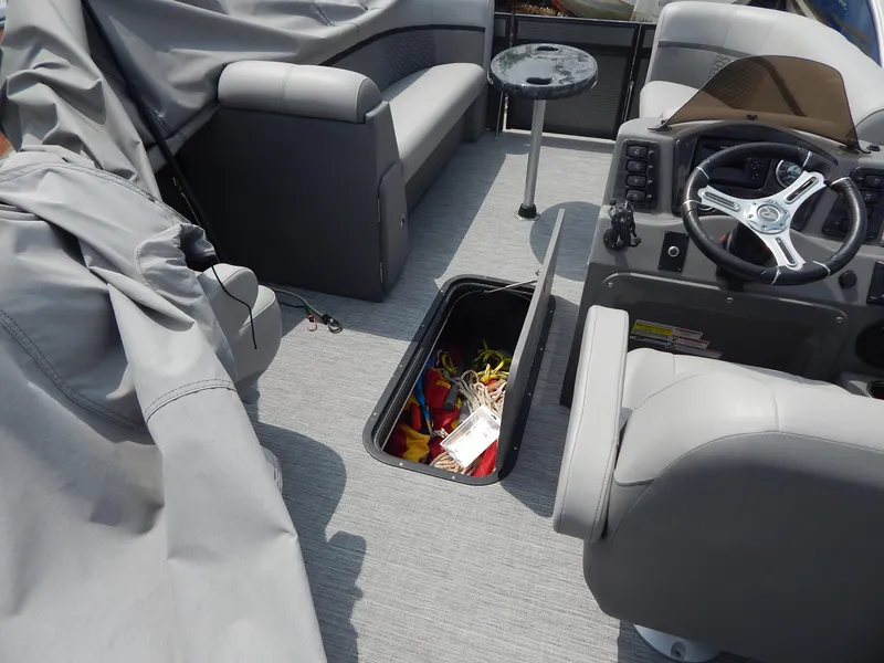 Slide: The Image of 2024 Qwest Splash Pad 822 boat interior with storage compartment and seating. - 36