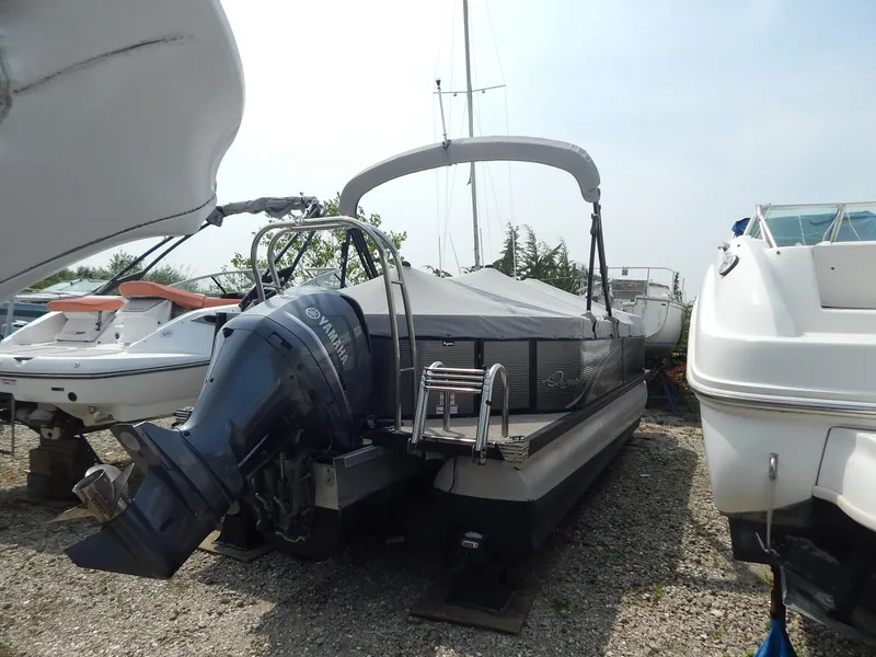 Slide: The Image of 2024 Qwest Splash Pad 822 pontoon boat with Yamaha outboard motor, docked on gravel. - 38