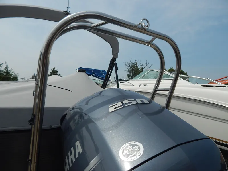 Slide: The Image of 2024 Qwest Splash Pad 822 boat with Yamaha 250 engine, docked under clear sky. - 6