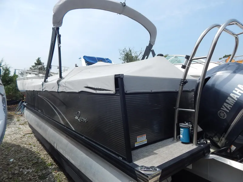 Slide: The Image of 2024 Qwest Splash Pad 822 pontoon boat with Yamaha engine, covered and docked outdoors. - 7
