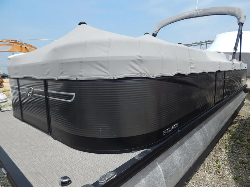 Slide: The Image of 2024 Qwest Splash Pad 822 pontoon boat with gray cover, docked outdoors. - 8