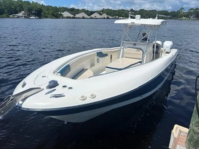 The Image of 2006 Hydra-Sports Vector 3300 CC boat on calm water, featuring sleek design and spacious deck. - 1