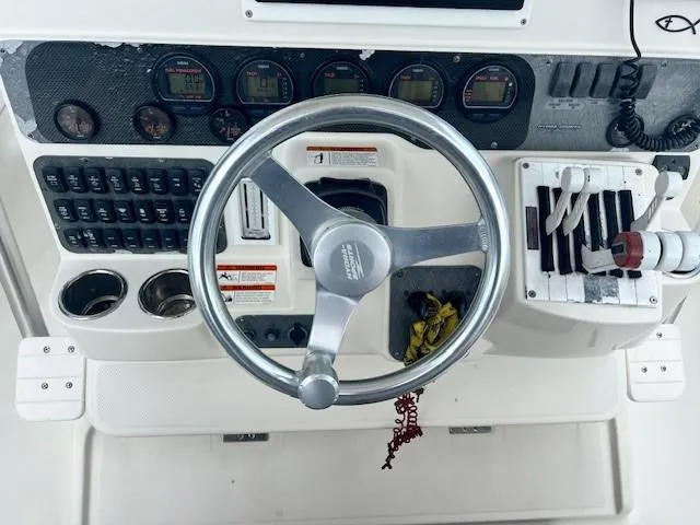 Slide: The Image of 2006 Hydra-Sports Vector 3300 CC boat dashboard with steering wheel and controls. - 23