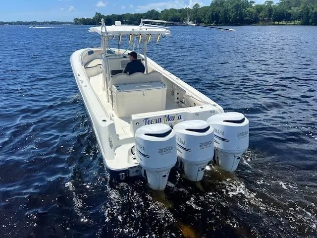 Slide: The Image of 2006 Hydra-Sports Vector 3300 CC boat with triple Yamaha 250 engines on a lake. - 3