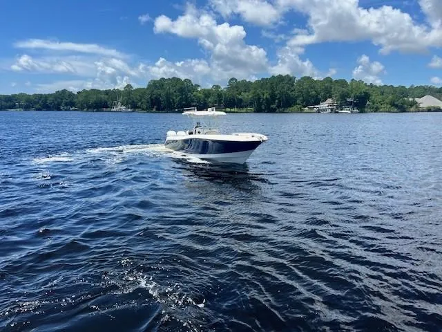 Slide: The Image of 2006 Hydra-Sports Vector 3300 CC cruising on a serene lake under a blue sky. - 6