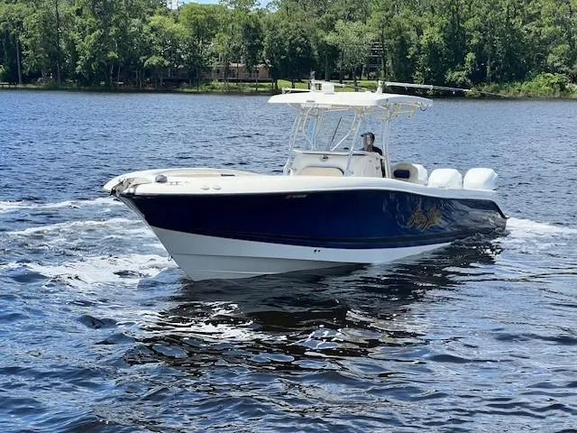 Slide: The Image of 2006 Hydra-Sports Vector 3300 CC boat cruising on a lake with forested shoreline. - 8