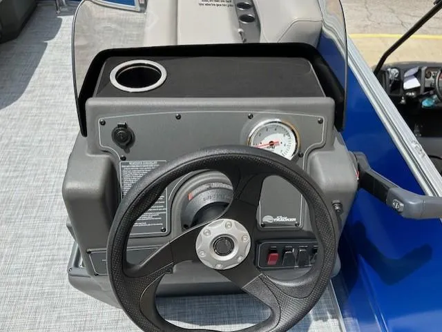 Slide: The Image of Steering console of 2026 Sun Tracker Party Barge 16 DLX with cup holder and gauge. - 5