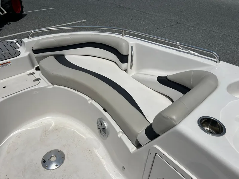 Slide: The Image of 2021 Starcraft Limited 1915 OB boat interior with cushioned seating and cup holders. - 11