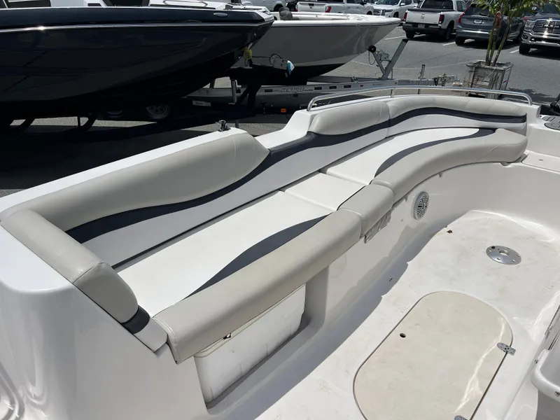 Slide: The Image of 2021 Starcraft Limited 1915 OB boat interior with curved seating and storage compartments. - 12