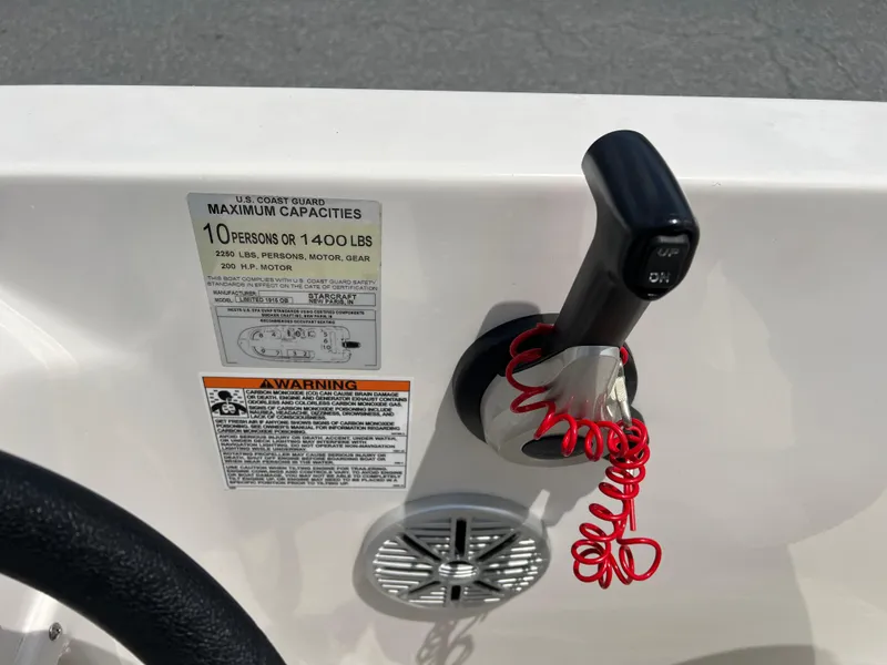 Slide: The Image of Control panel of 2021 Starcraft Limited 1915 OB boat with capacity and safety warnings. - 18