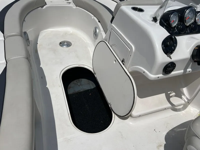 Slide: The Image of 2021 Starcraft Limited 1915 OB boat interior with open storage compartment and control panel. - 21