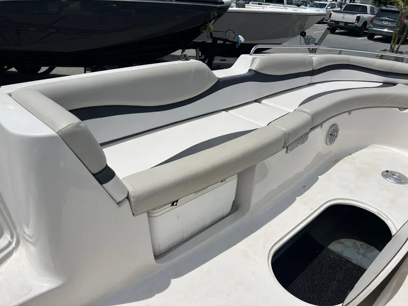 Slide: The Image of 2021 Starcraft Limited 1915 OB boat interior with cushioned seating and storage compartment. - 22