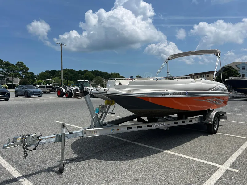 Slide: The Image of 2021 Starcraft Limited 1915 OB boat on trailer in parking lot under blue sky. - 5