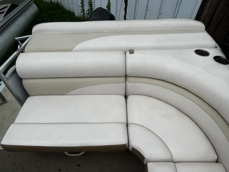 Slide: The Image of 2015 Harris Sunliner 220 boat seating with cup holders, featuring white and beige upholstery. - 4