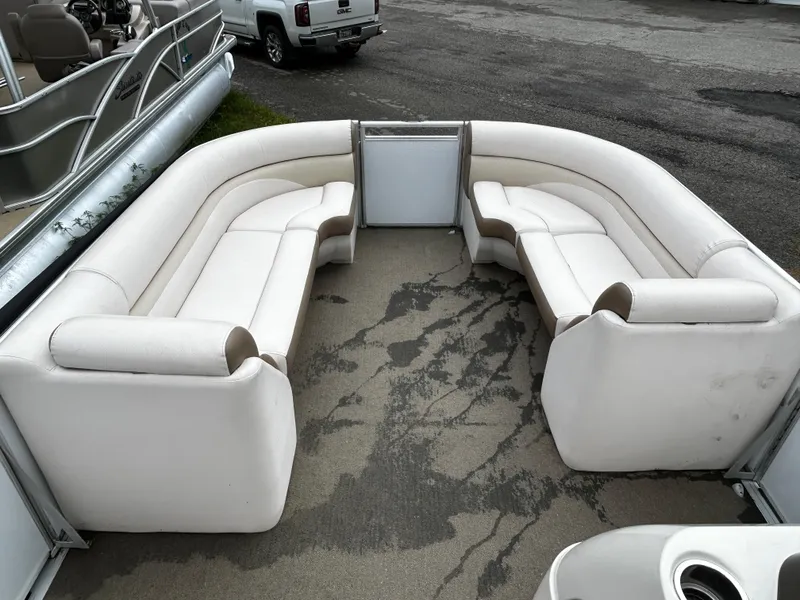 Slide: The Image of 2015 Harris Sunliner 220 pontoon boat with white seating and spacious deck area. - 6