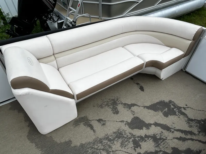 Slide: The Image of 2015 Harris Sunliner 220 boat seating, white and beige upholstery, outdoor setting. - 7