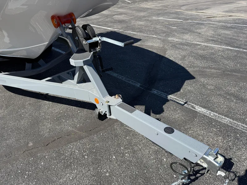 Slide: The Image of Trailer hitch of a 2025 MasterCraft NXT22 boat on asphalt parking lot. - 11