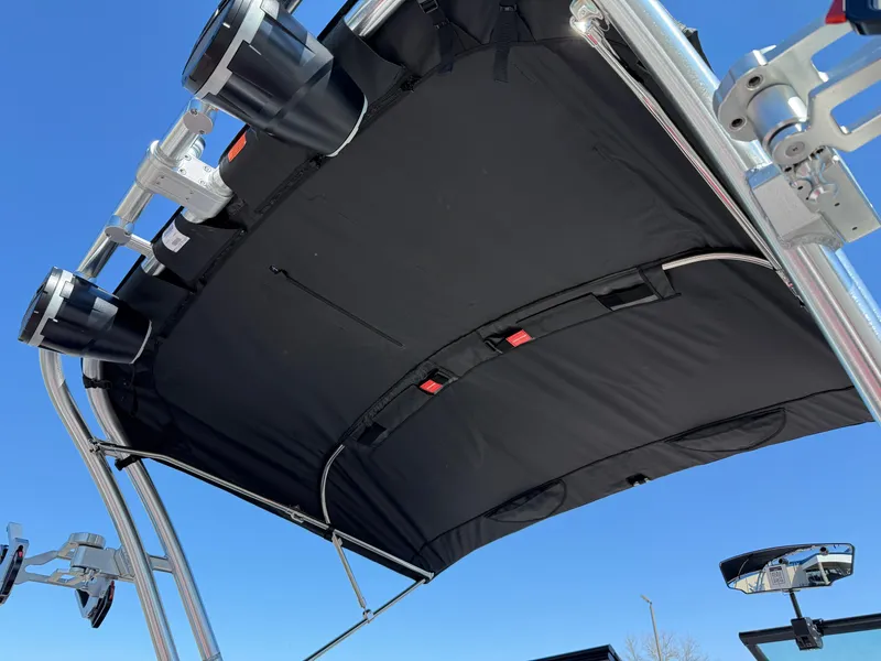 Slide: The Image of 2025 MasterCraft NXT22 boat canopy with speakers against clear blue sky. - 13
