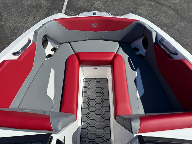 Slide: The Image of 2025 MasterCraft NXT22 boat interior with red and gray seating, hexagonal floor design. - 16